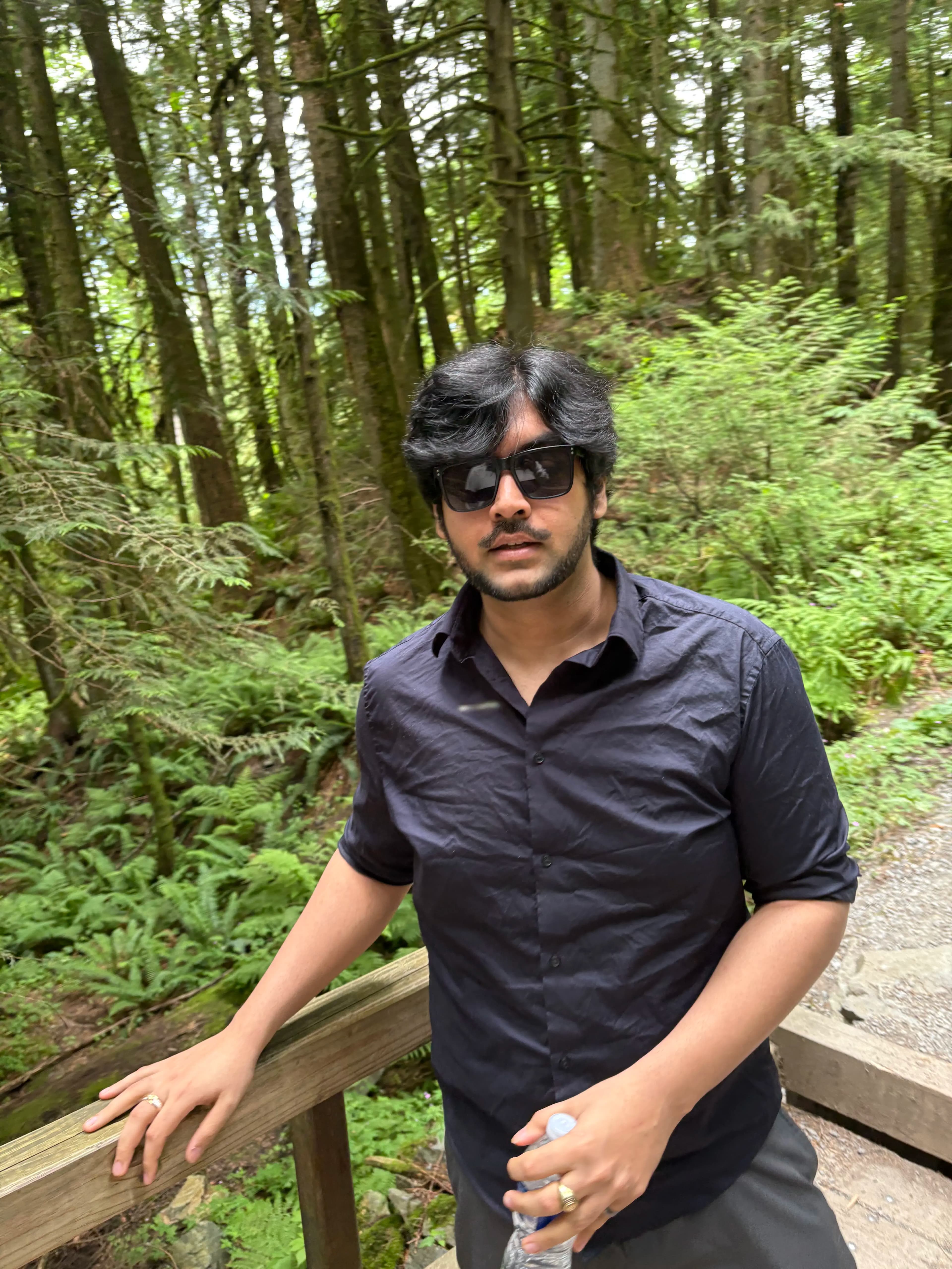 Portrait of Anadi Mishra in a forest wearing sunglasses
